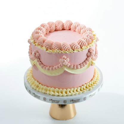 Pink and yellow Disney Aurora Sleeping Beauty princess theme cake on a decorative stand 